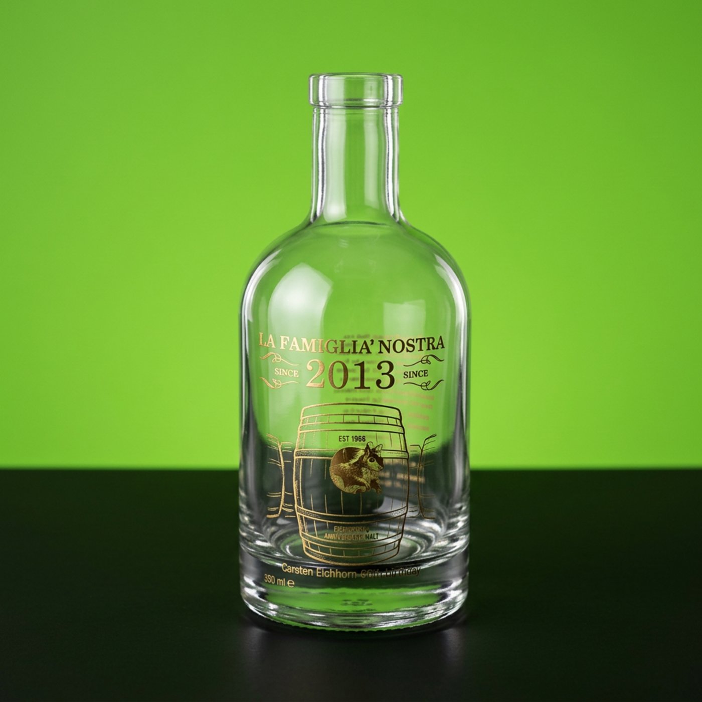 Klarglasflasche mit goldenem Siebdruck-Motiv